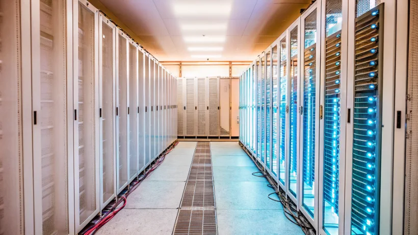 Modern data center with rows of server racks illuminated by blue LED lights